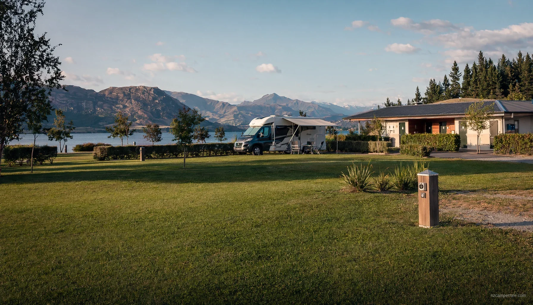 A serviced NZ holiday park with motorhomes on tidy pitches